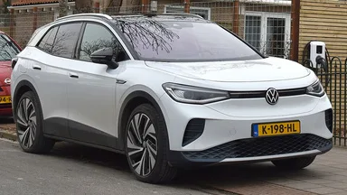 Volkswagen ID.4 parked beside a home EV charger